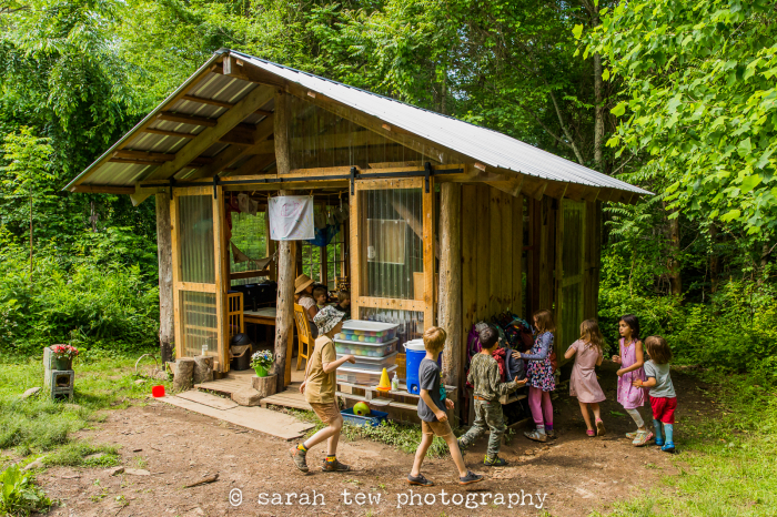 Students at an alternative elementary school entering their rustic open-air classroom at the beginning of a school day