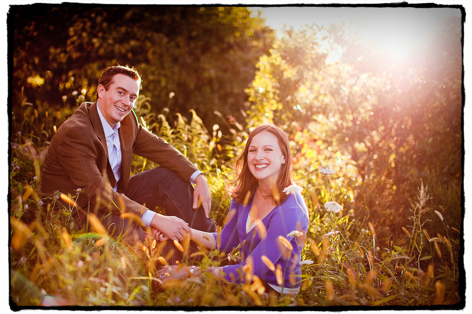 Engagement Portraits: Amy & Mike in the grass at Brooklyn Bridge Park.