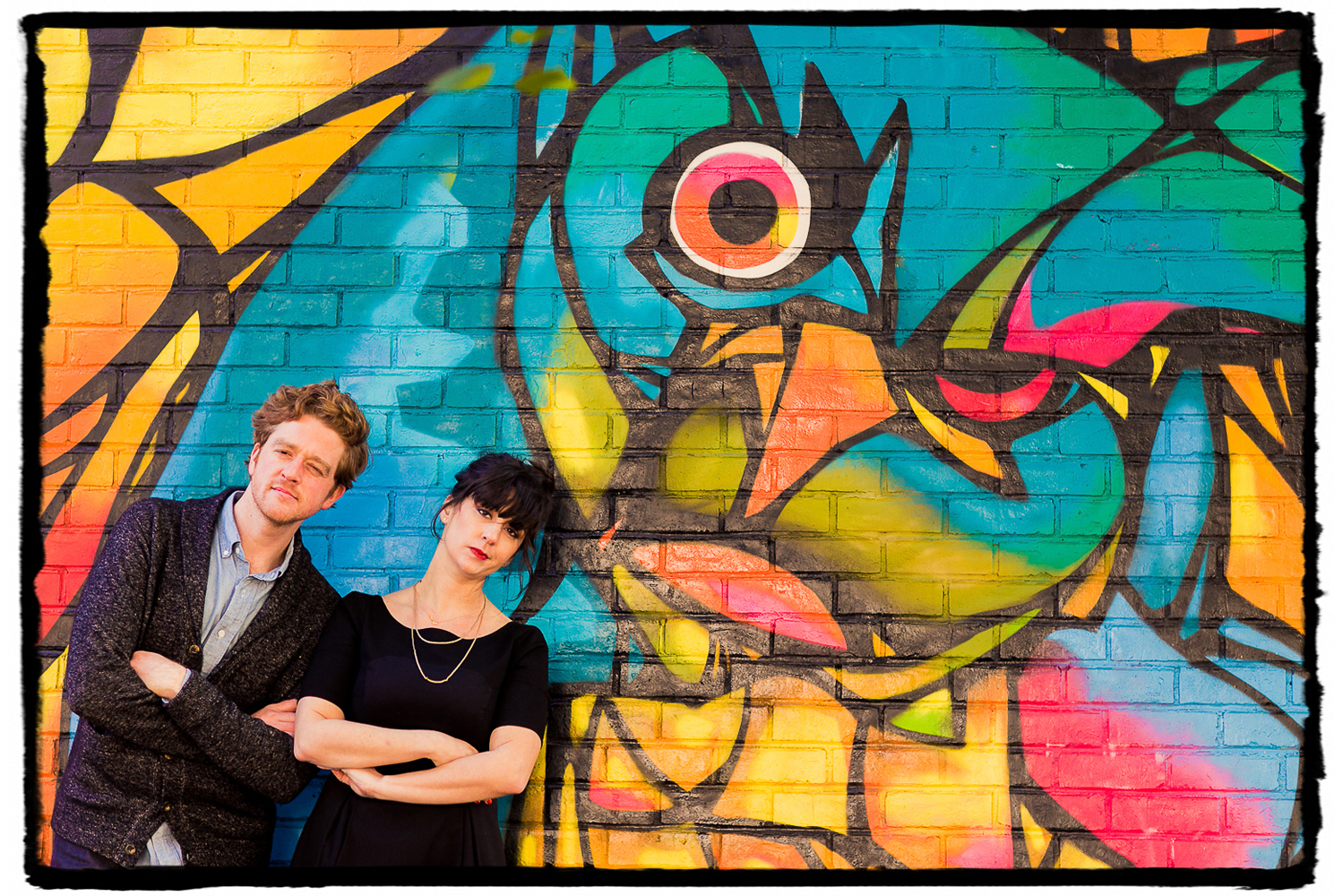 Engagement Portraits: Alli & Parker make funny faces with the street art in DUMBO.