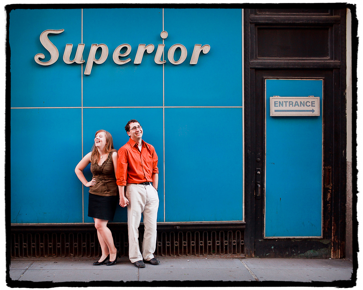 Engagement Portraits: Katie & Jason under some auspicious signage in the Flatiron area of Manhattan.