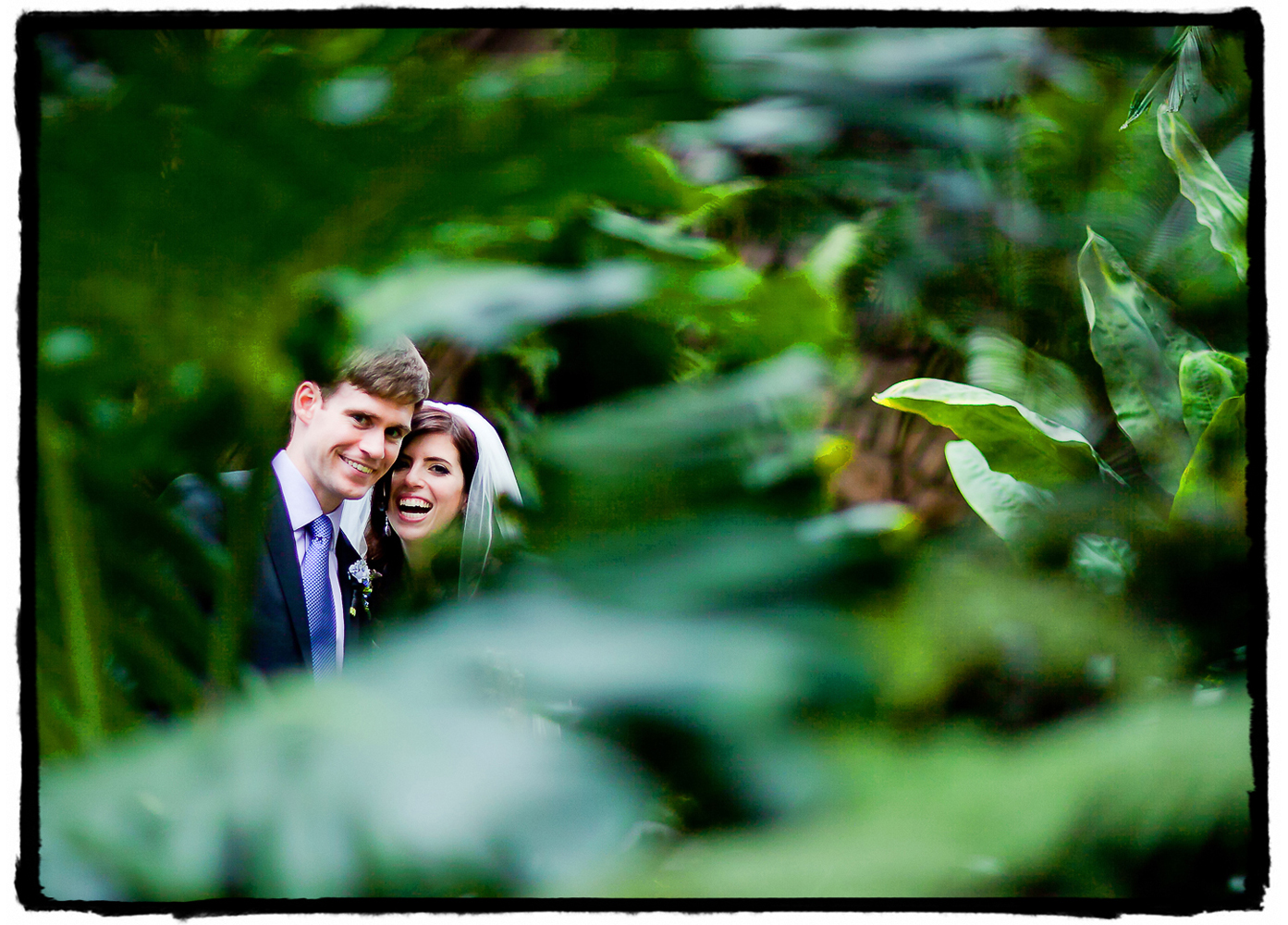 I shot this portrait through the foliage at Brooklyn Botanic Garden. I love the bokeh framing them in foreground and background.