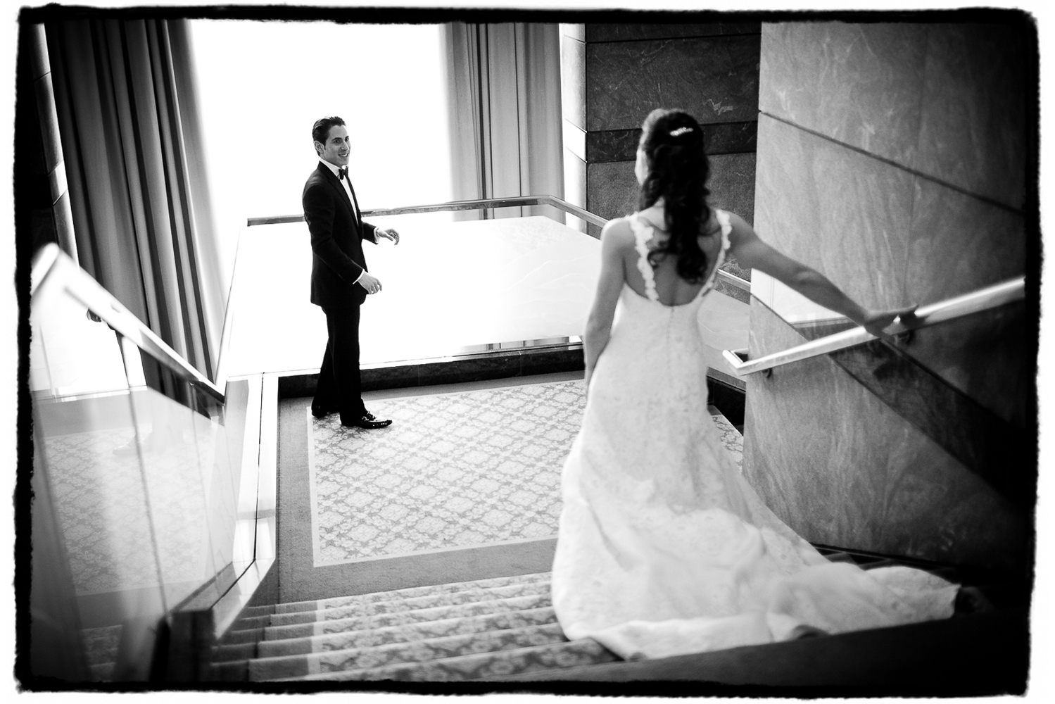 Aaron beholds his bride coming down the stairs at The Ritz-Carlton Battery Park.
