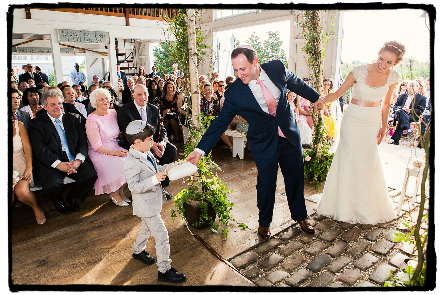 The ring bearer carefully makes his delivery in the chapel at Bonnet Island Estate.