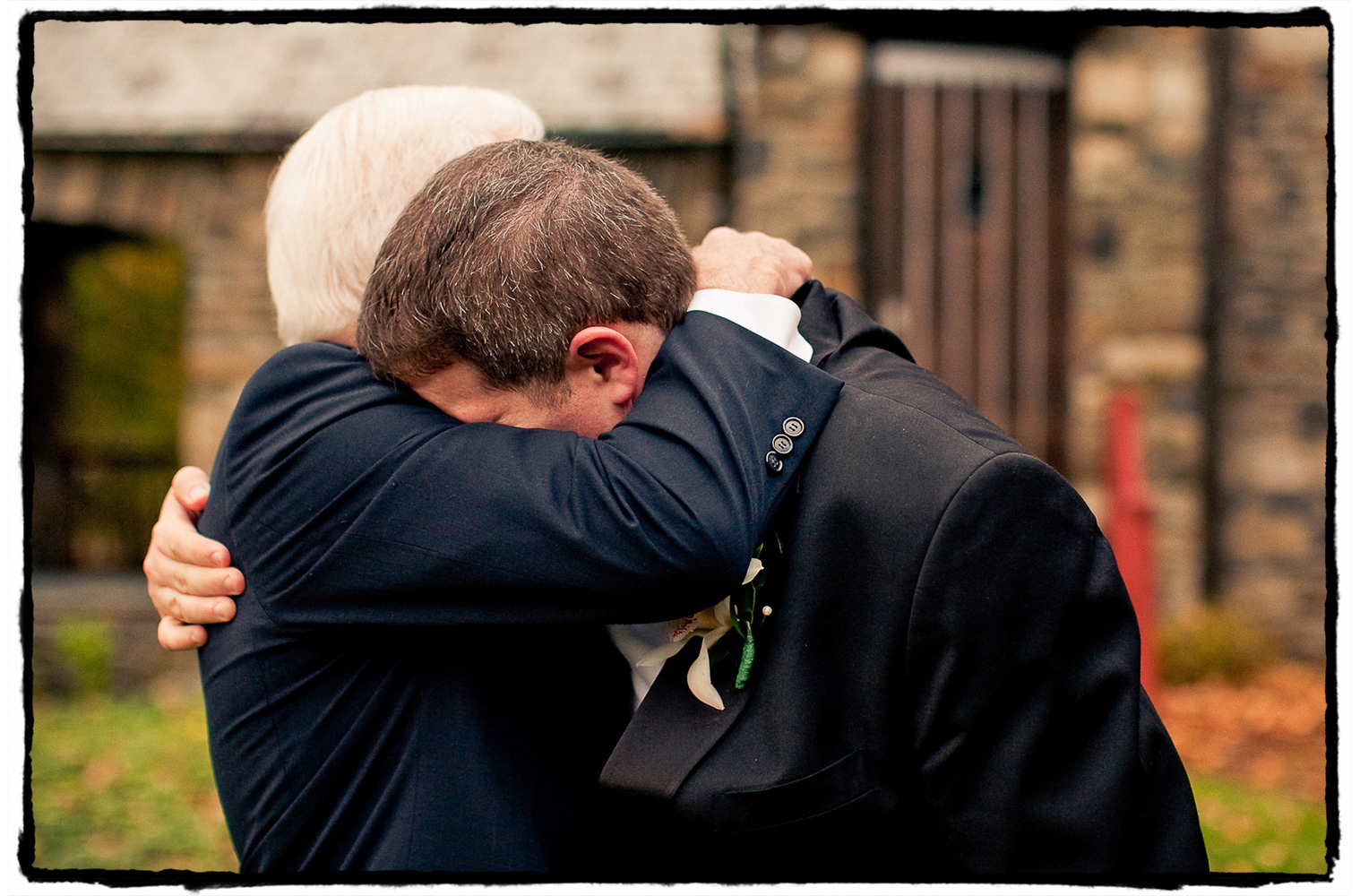 This groom shares an emotional hug with his father after marrying the love of his life.