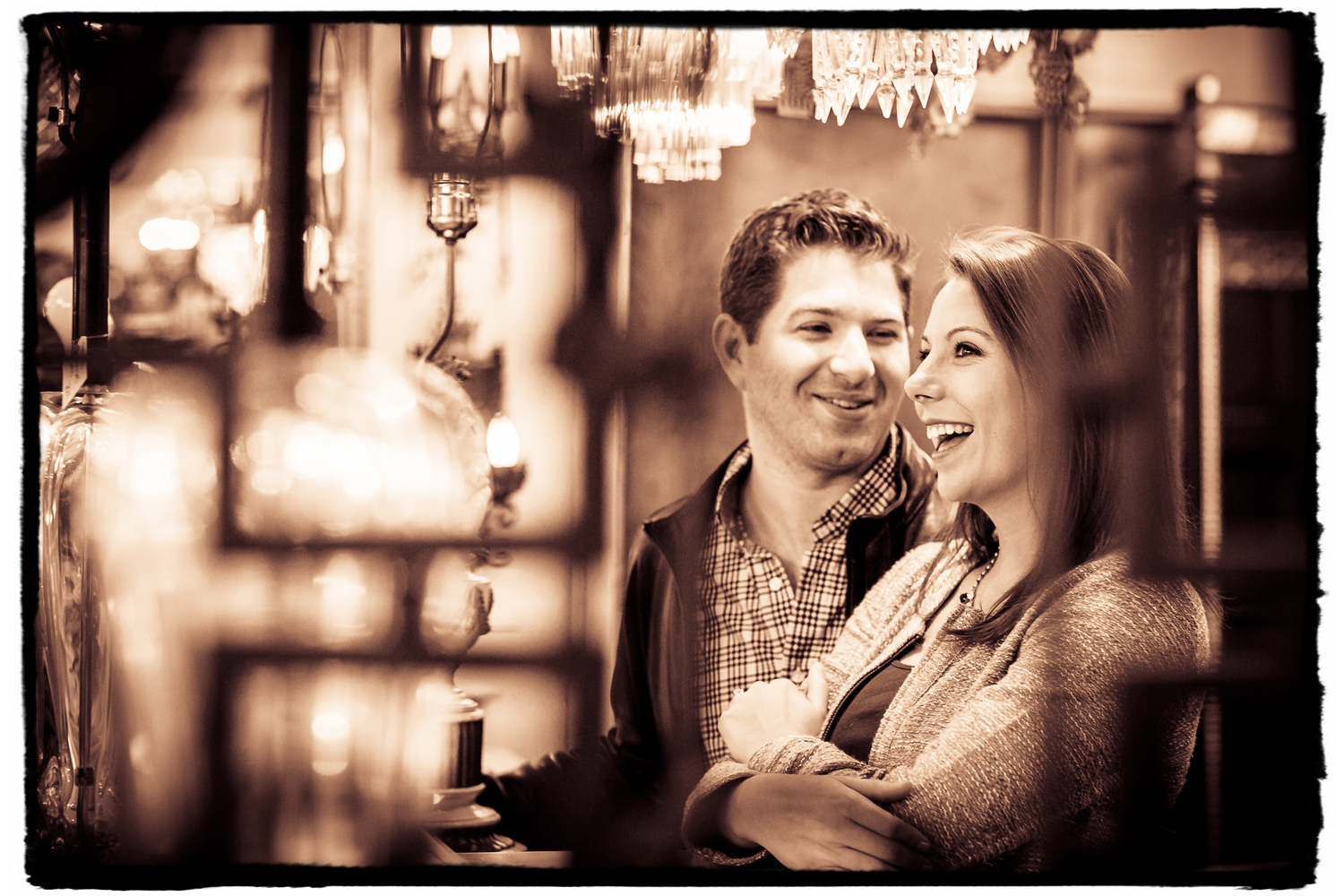 Engagement Portrait: Meghan & Terence check out the crystal chandeliers in the antique store across the street from their building.