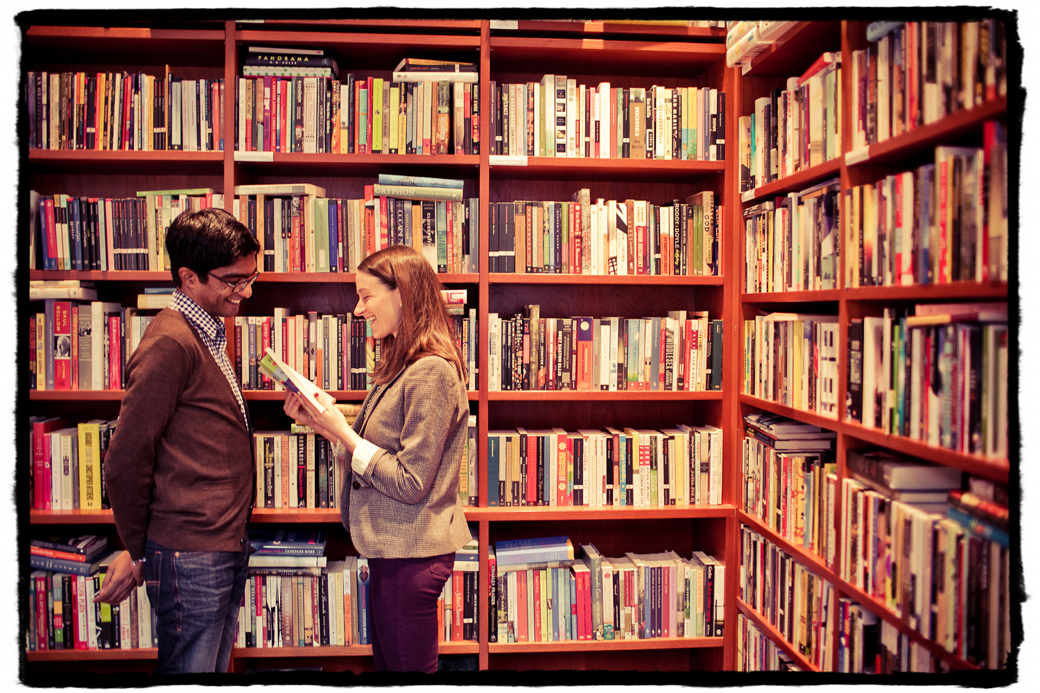 Engagement Portrait: Katie reads a passage to Sharmilan in their local bookstore in Chelsea.