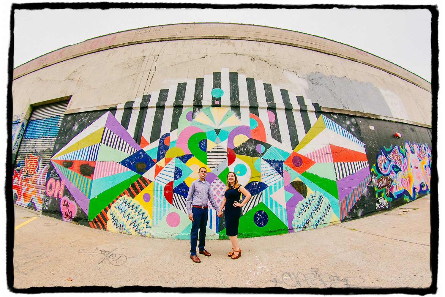 Engagement Portrait: Jessie & Steve let me immortalize them through a fisheye lens with the street art in Greenpoint, Brooklyn.